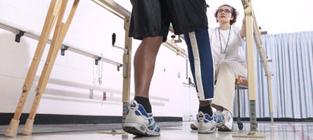 physical therapist with man on crutches