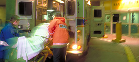 Man on stretcher being put into ambulance